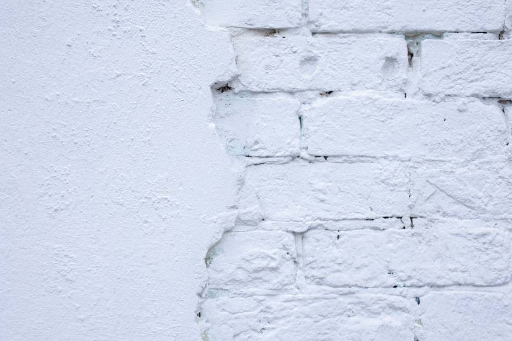 White paint on a wall of bricks and plaster