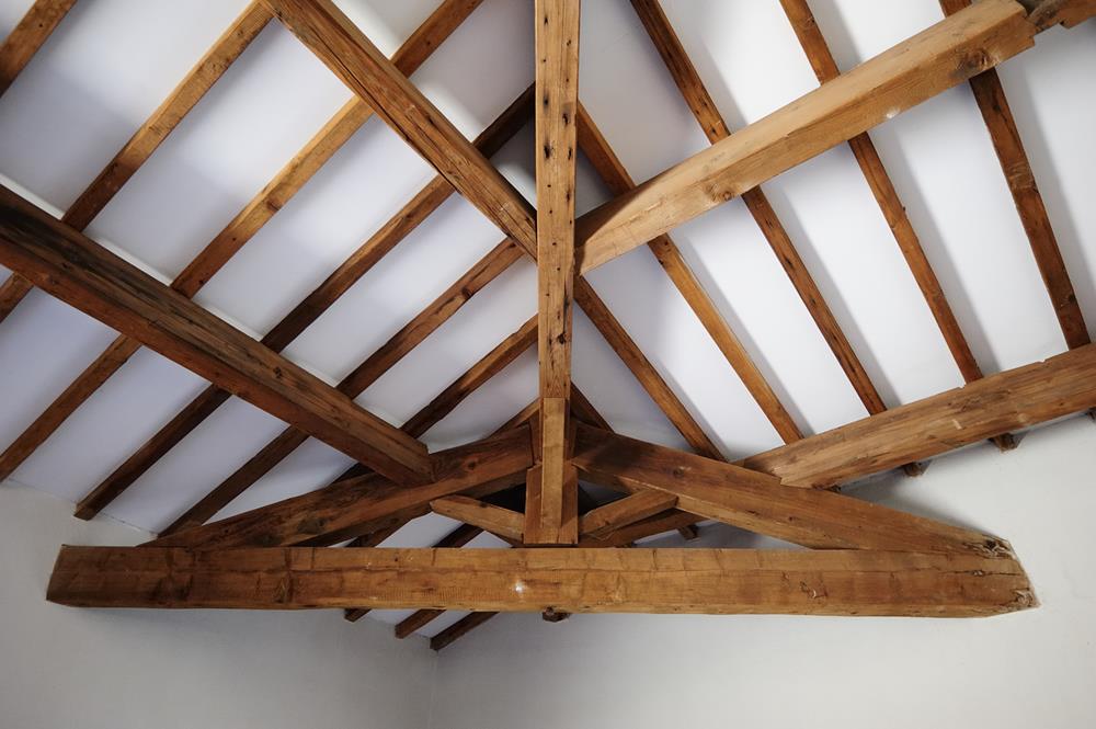 Exposed roof structure of a house with ceiling beams