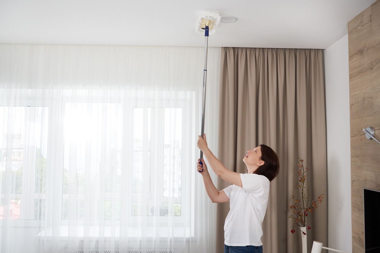 woman cleaning the ceiling
