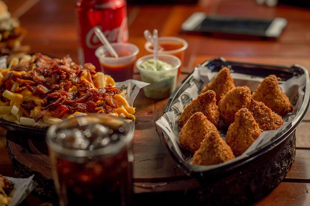A serving of the traditional Southern fried chicken with some fries and drinks