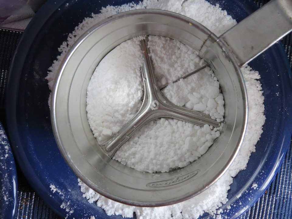sifting flour using a flour sifter