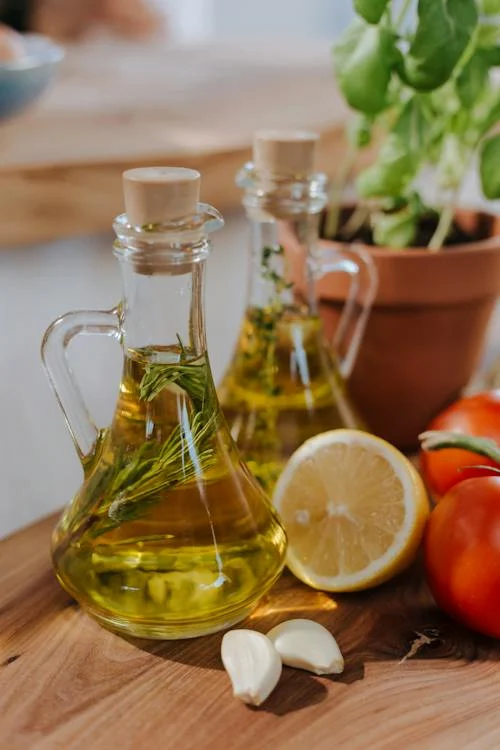 Different types of cooking oils in clear glass bottles