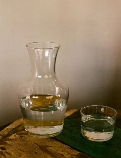A Picture Portraying a Transparent Glass Pitcher with Water Beside a Glass.