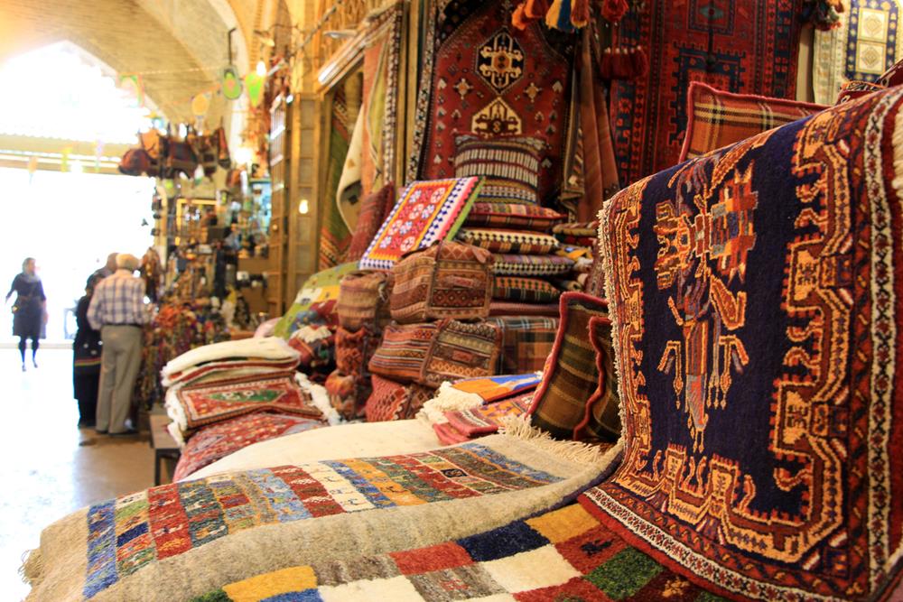 Colorful Persian carpets sold in the bazaar of Shiraz, Iran