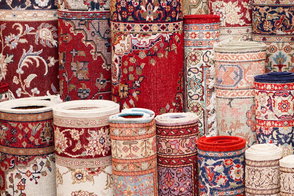 Various handmade Persian rugs in a shop