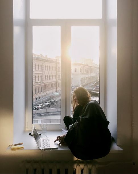 woman sitting on bay window
