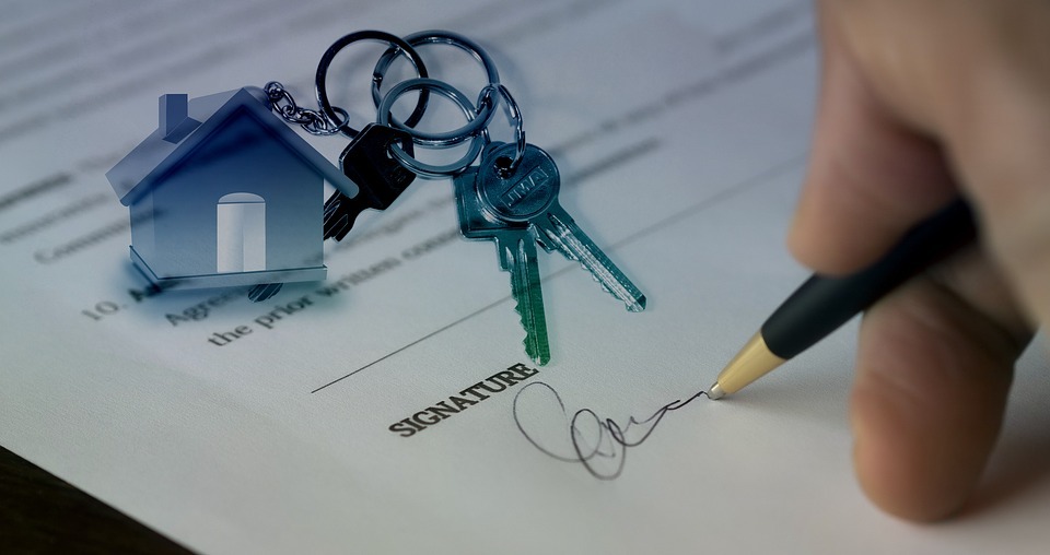 person signing a contract for a house