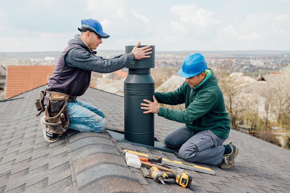 Workers installing a chimney