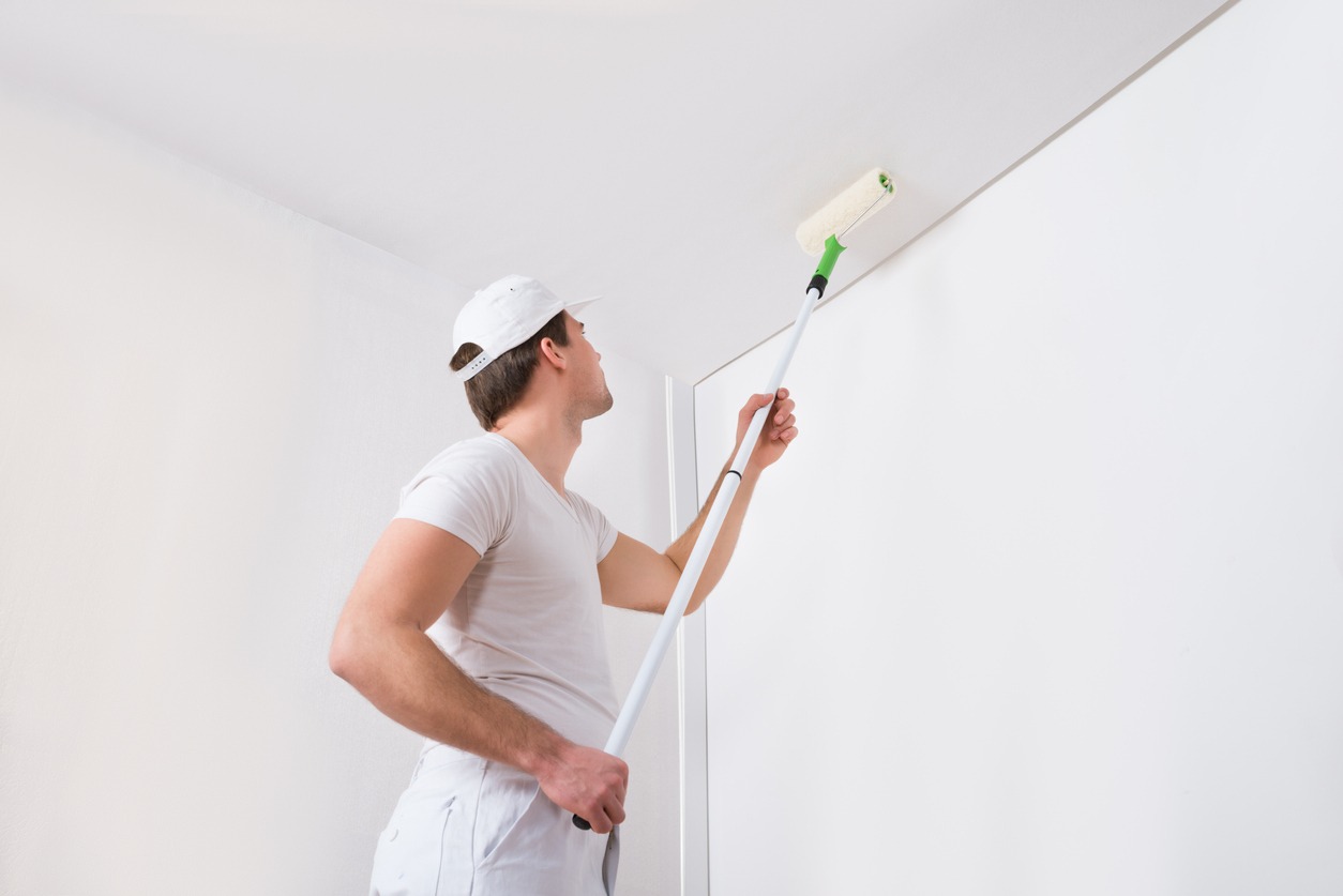 man painting the ceiling
