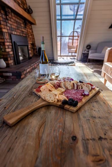 A charcuterie board served with wine