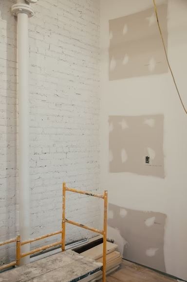 A room with plaster on the walls