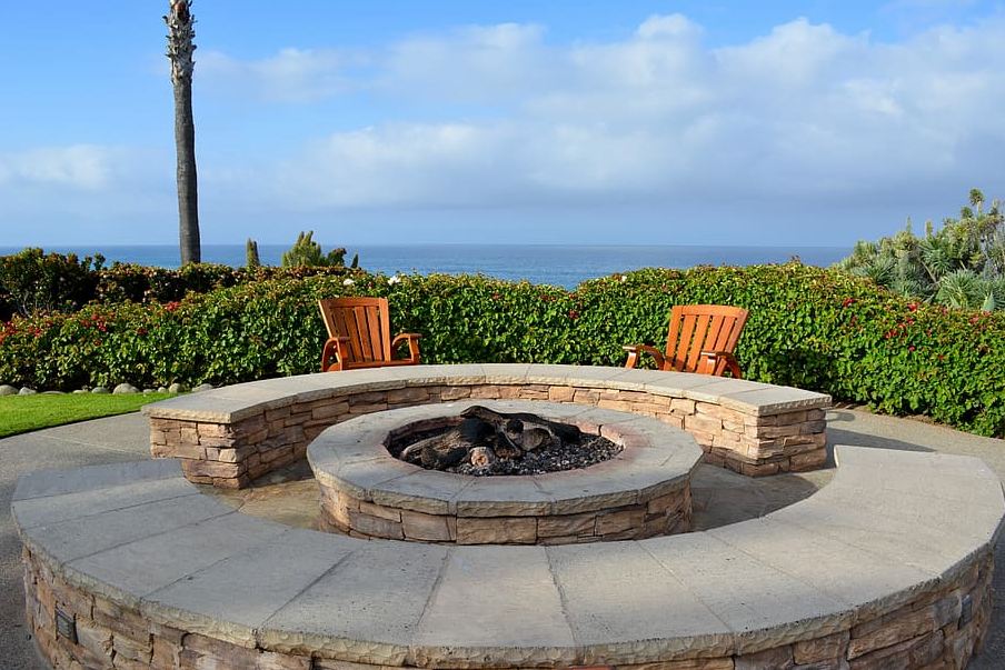 A stone fire pit with stone benches