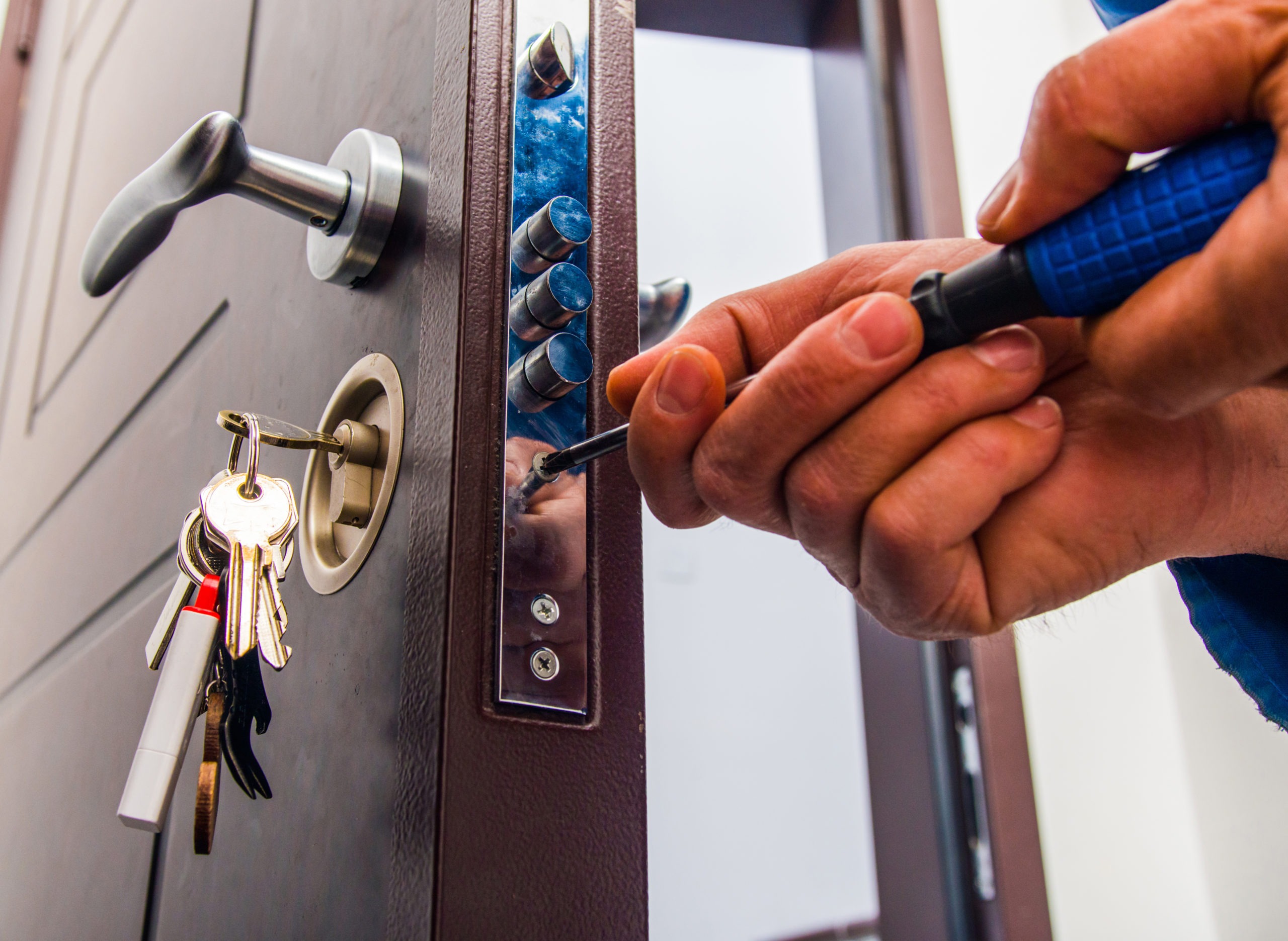 Handyman repairs the door lock