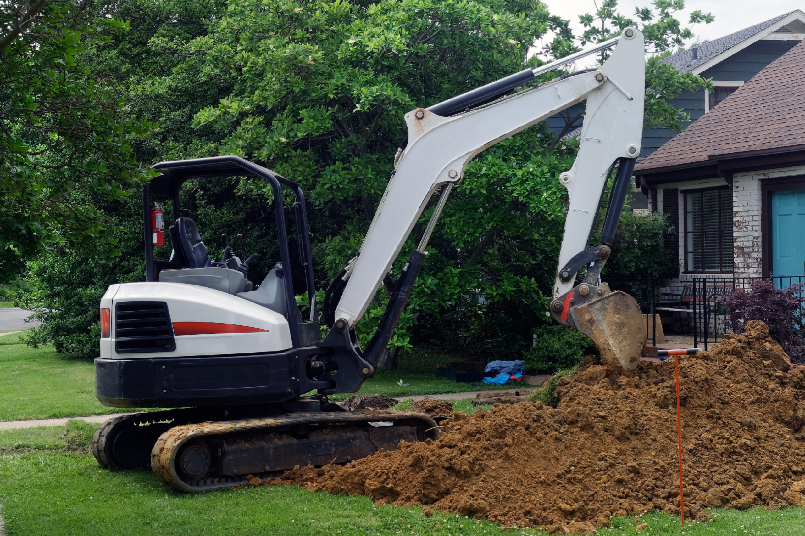 Major homeowner problem: Excavator digging out lawn to access wa