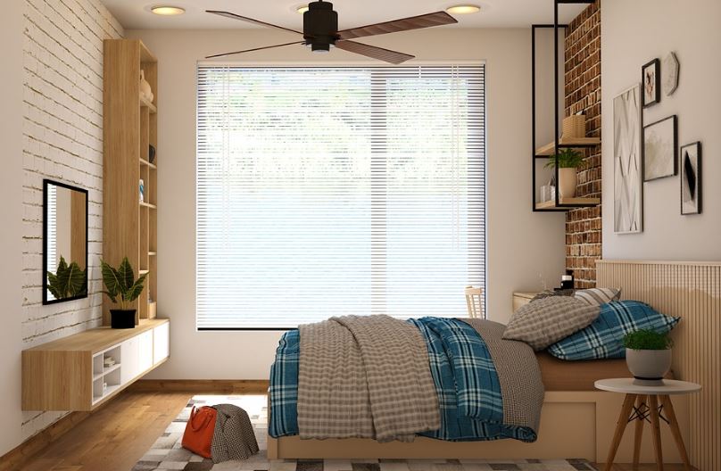 a ceiling fan in a bedroom with furniture and decor