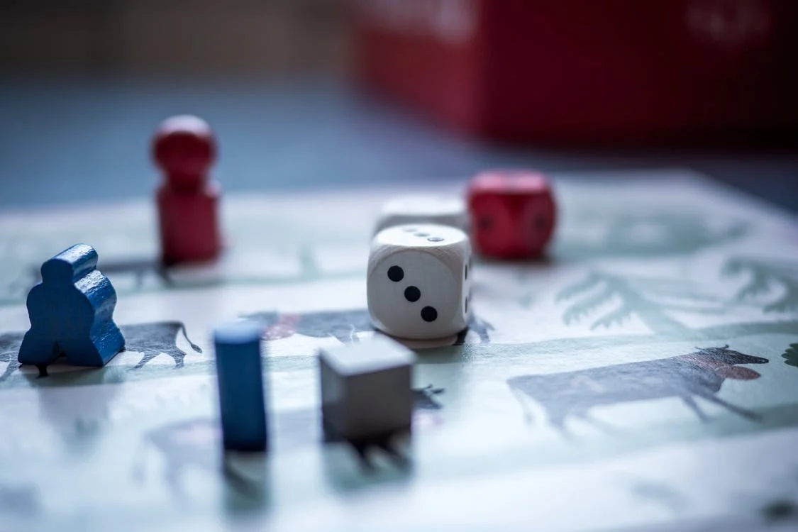 Dices and wooden pieces on a board game