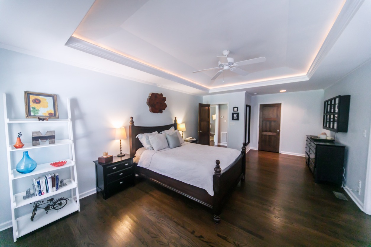 a bedroom with a tray ceiling