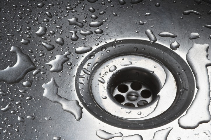 Water Drops Around Plughole In Stainless Steel Sink