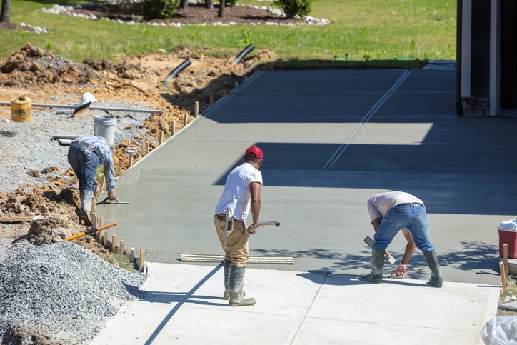 Hispanic men working on a new concrete driveway