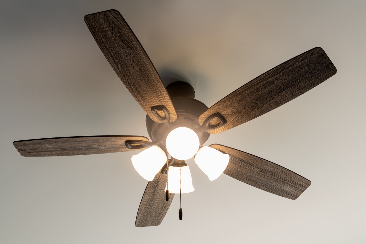 a wooden ceiling fan with lights