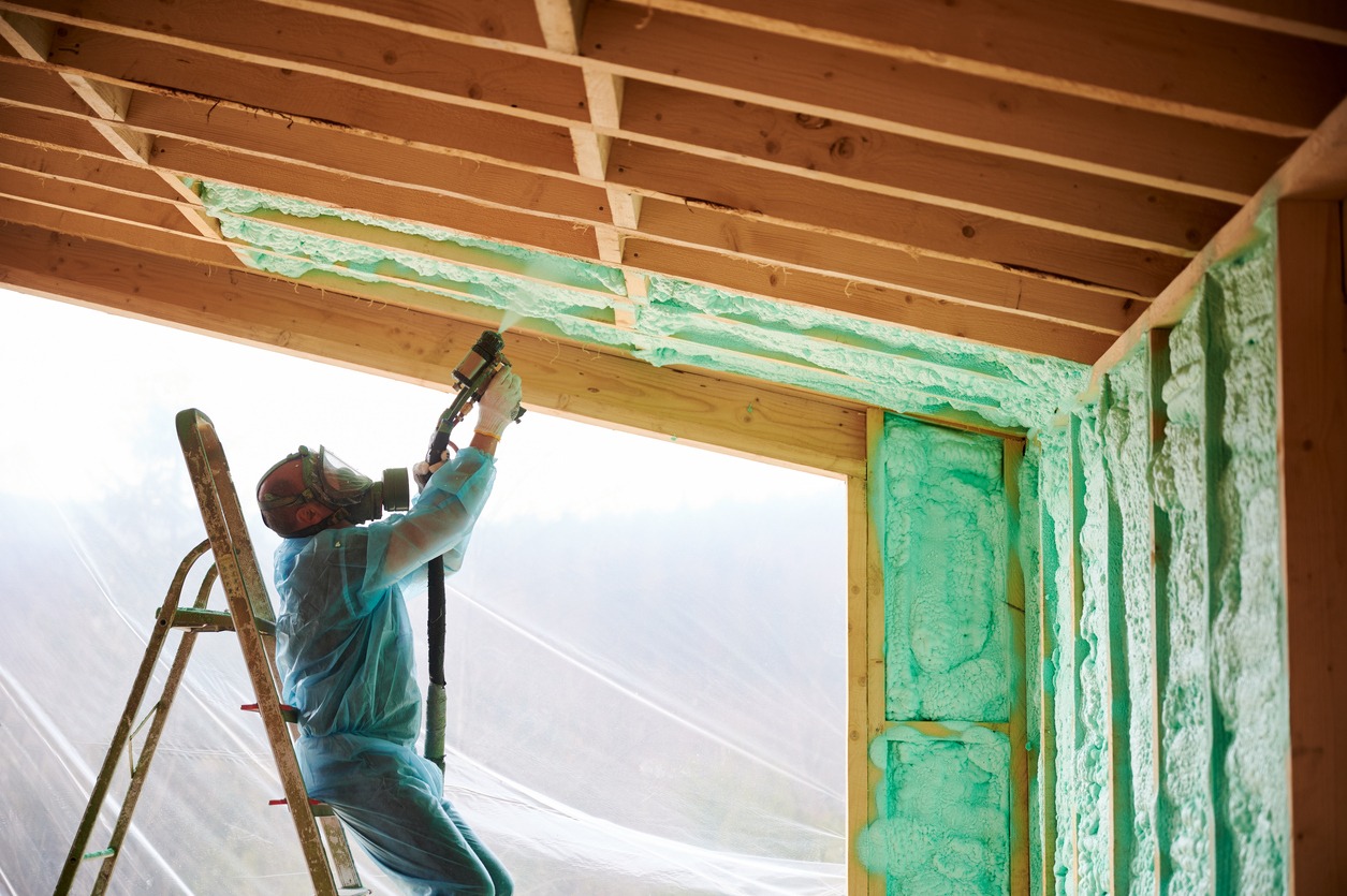man installing ceiling insulation
