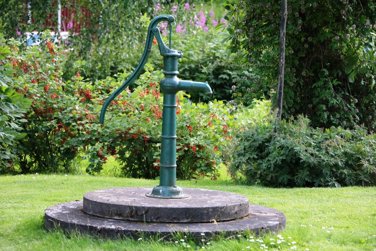 a hand-operated water pump to get water from a driven well