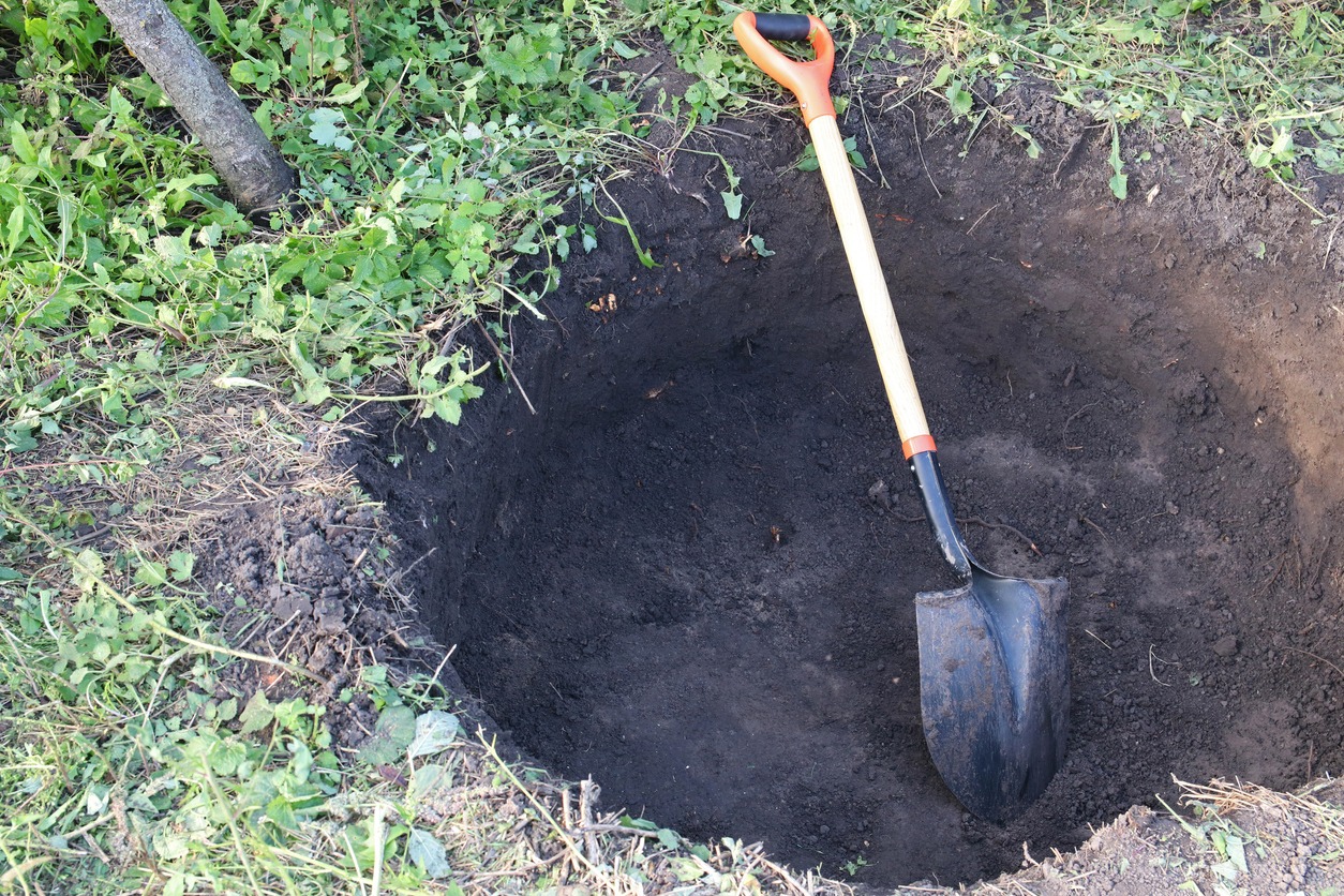 digging the ground with a shovel