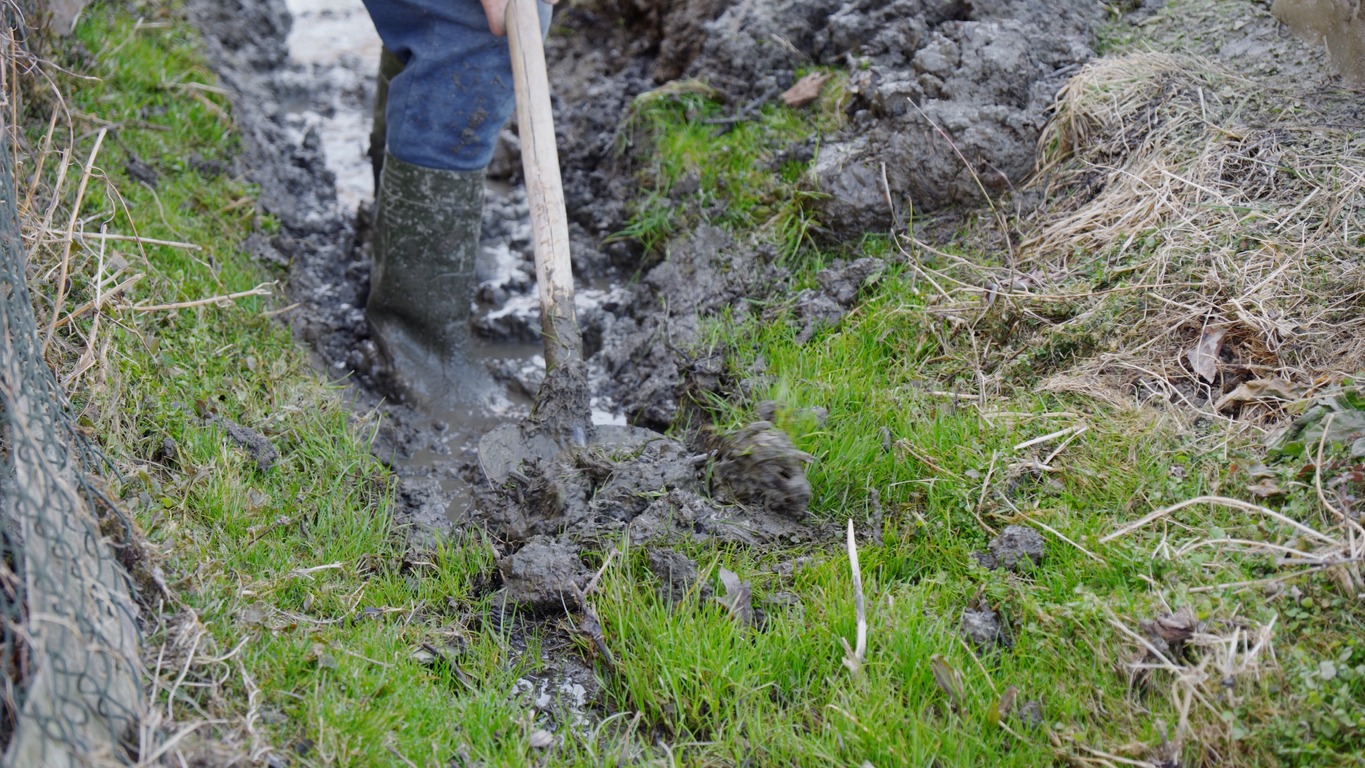 man digging soil