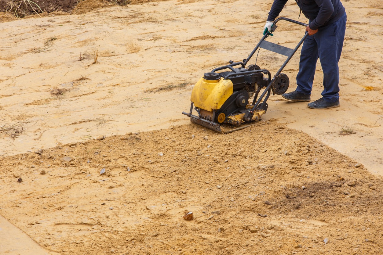 man using a compaction equipment
