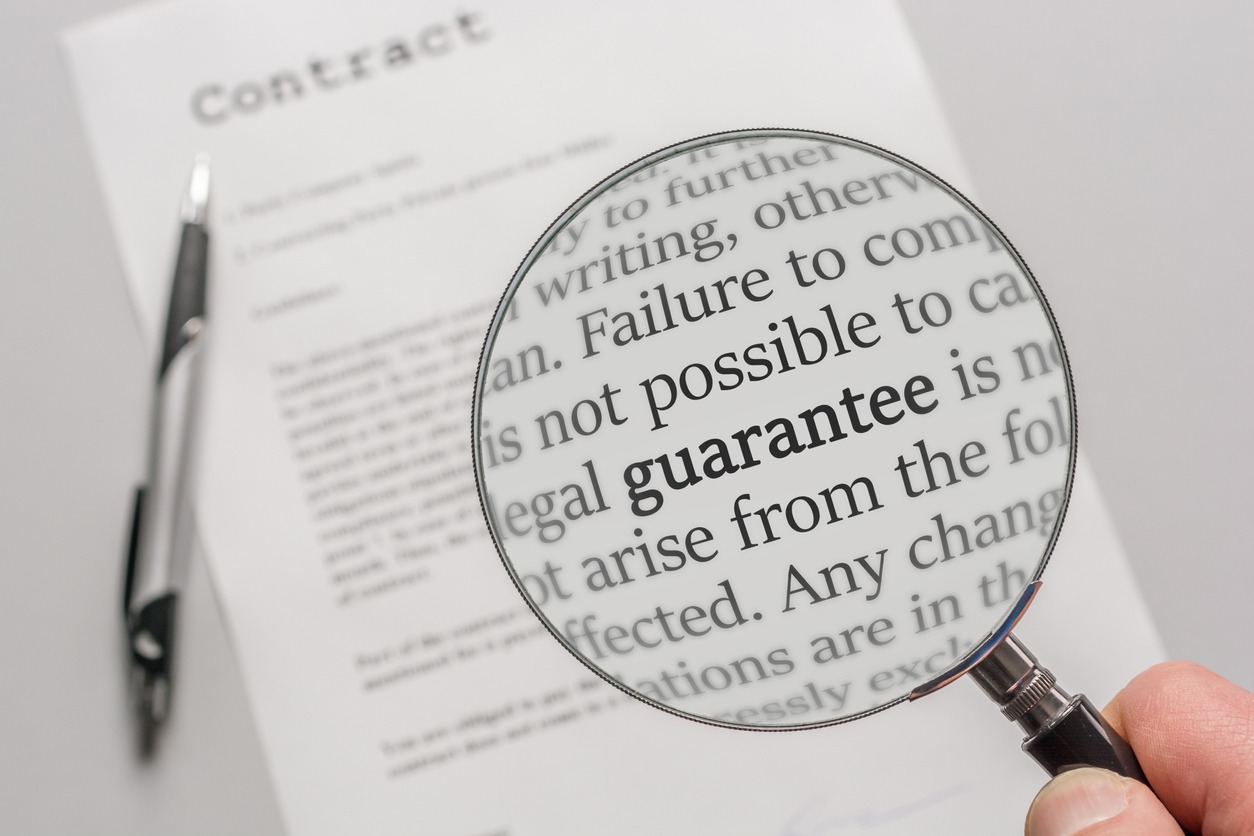 Guarantee conditions of a contract are checked carefully with a magnifying glass