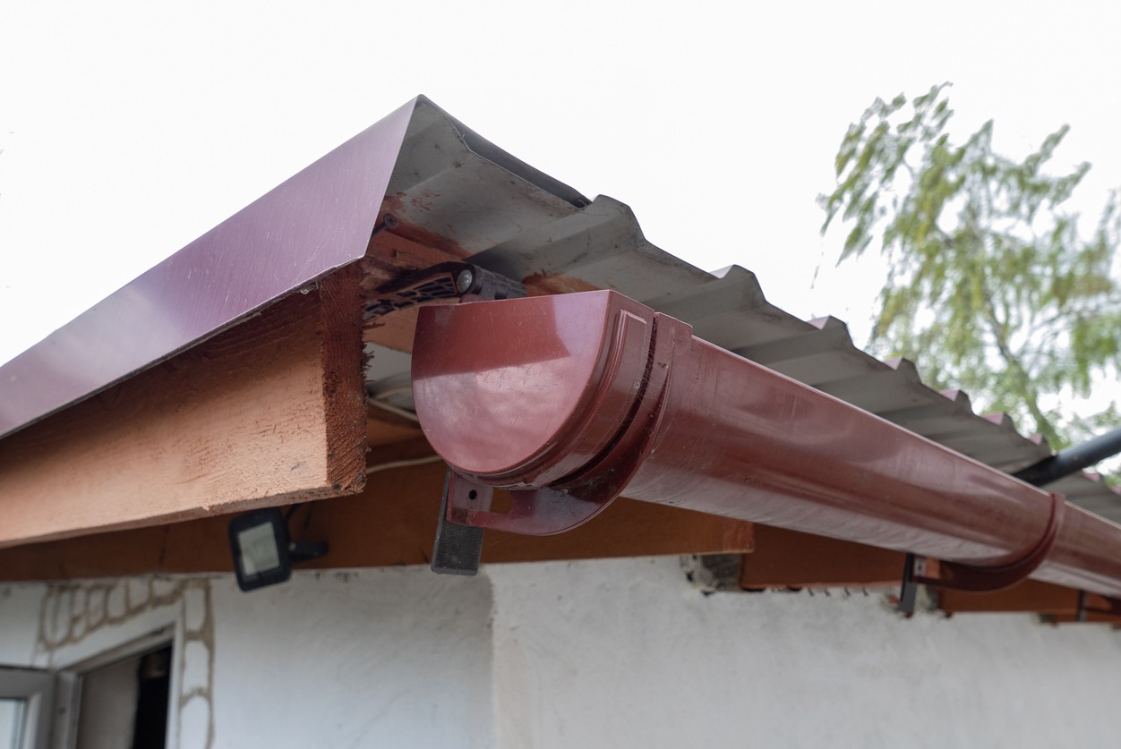 a half-round gutter system for a metal roof