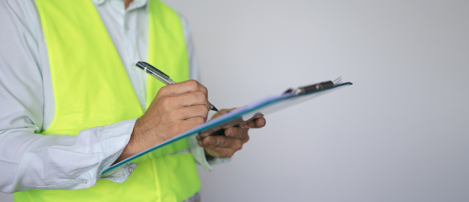 a construction worker holding a checklist
