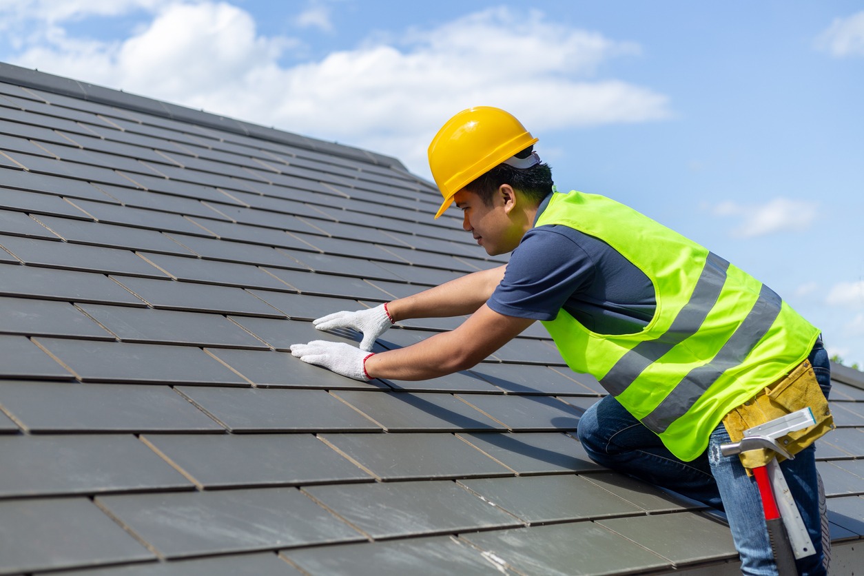 a contractor repairing a roof