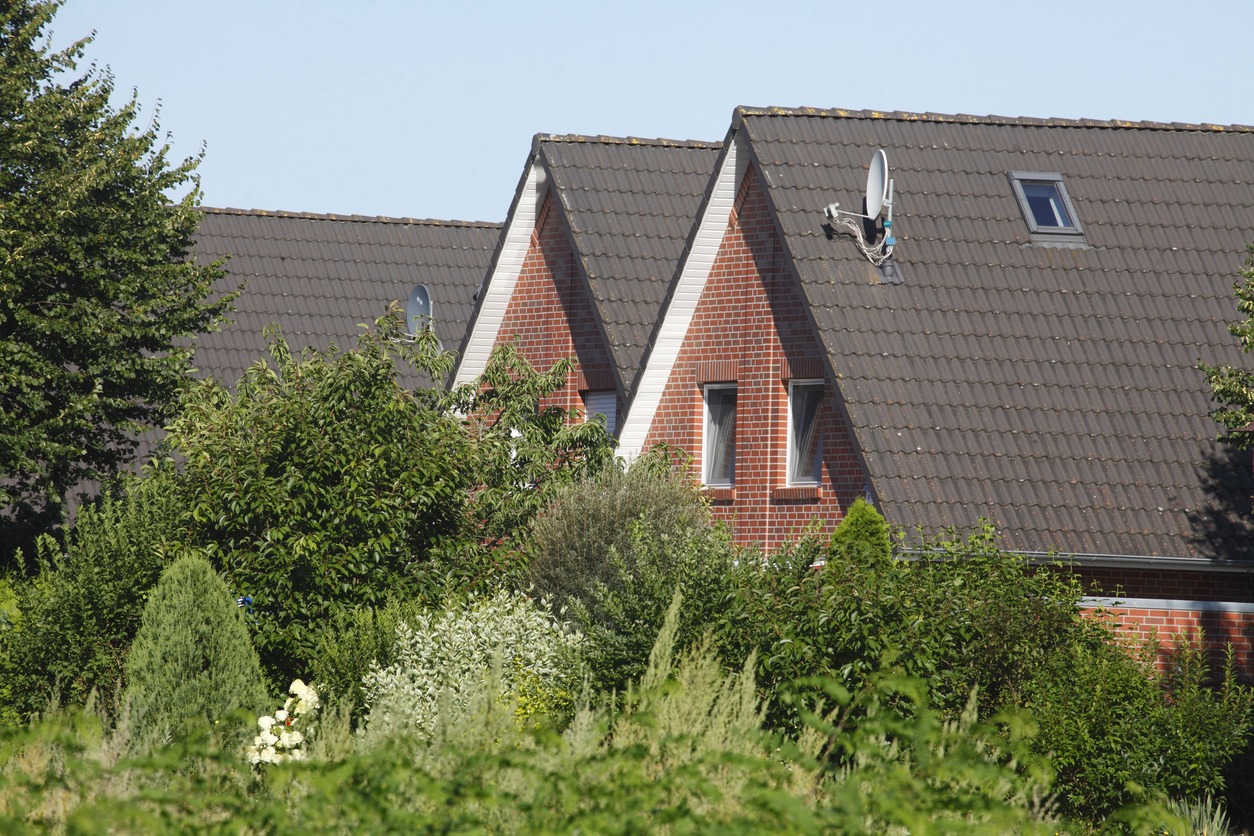 a couple of brick houses with high-pitched roofs