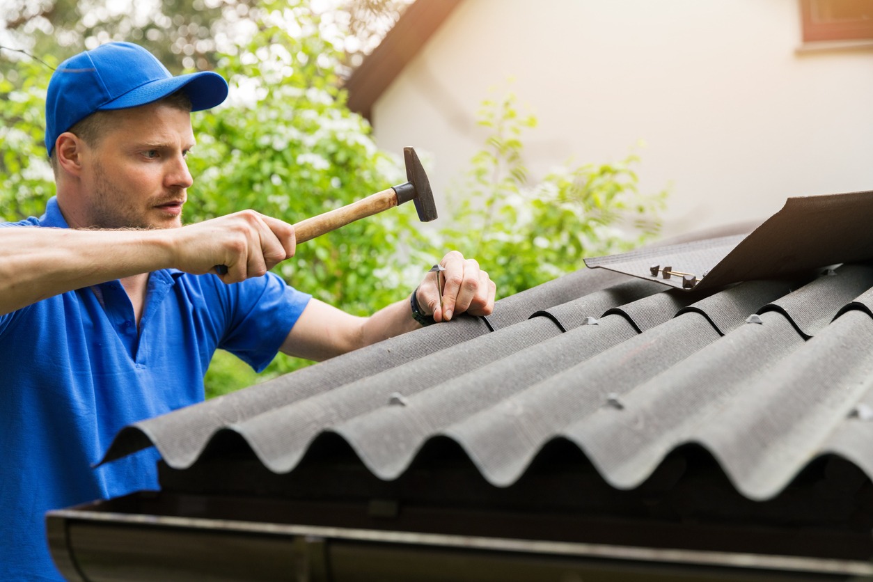 a man installing bitumen roof sheets