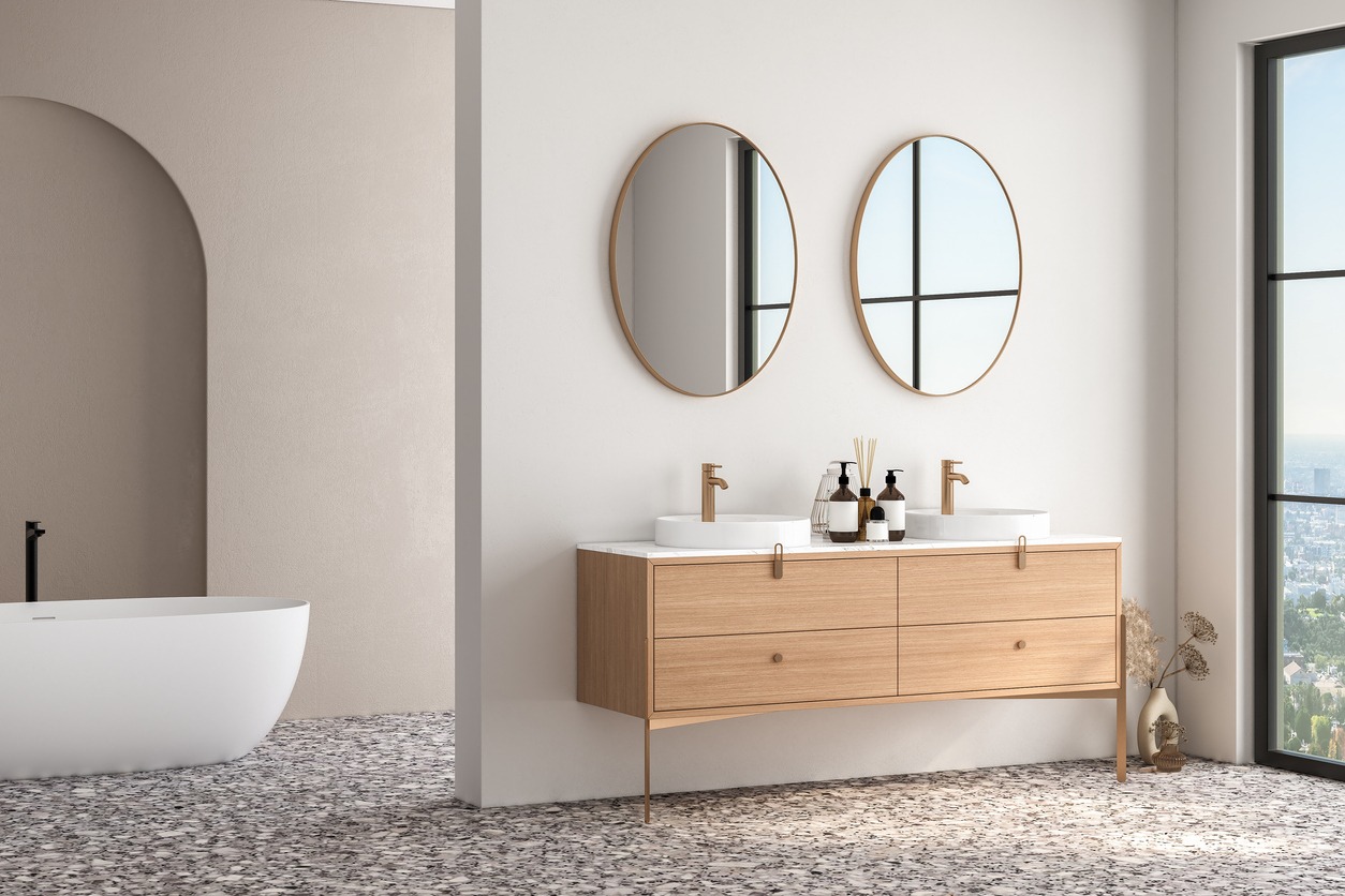 Bright bathroom interior with double sink and mirror, terrazzo floor, bathtub, plants