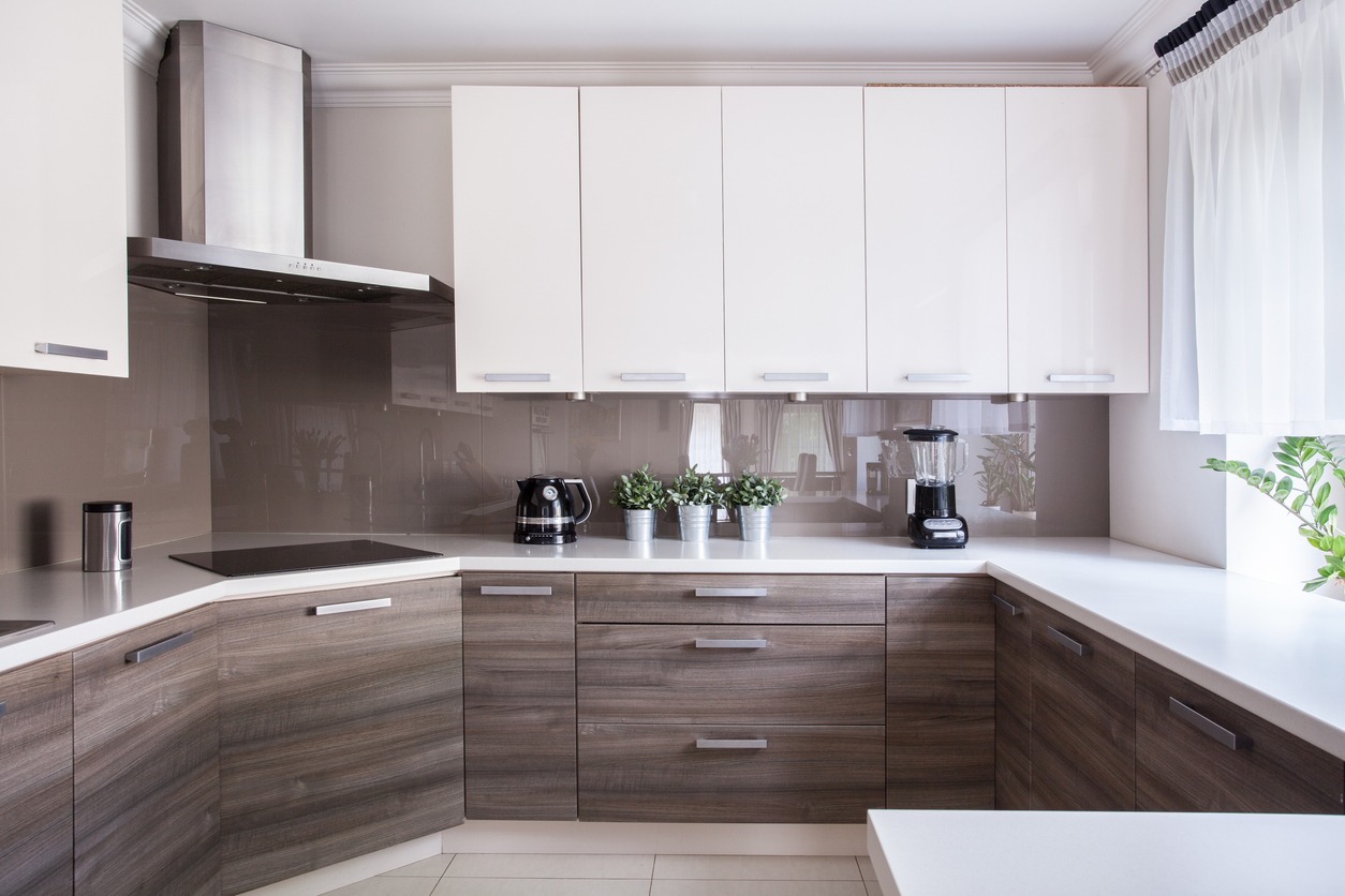 Cozy beige kitchen interior with wooden cupboards