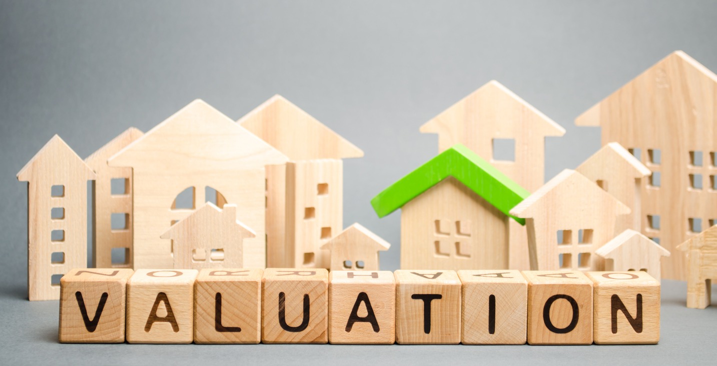 Wooden blocks with the word Valuation and many houses