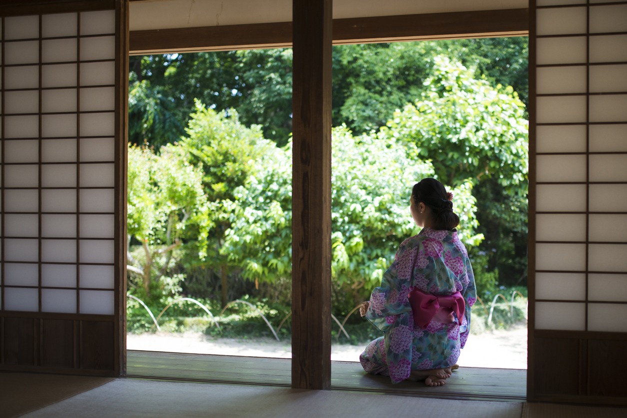 a Japanese woman sitting on a hallway