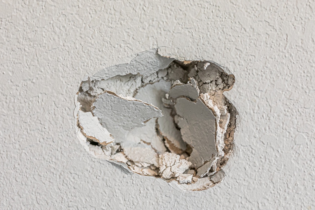 a hole in the wall caused by fist-punching