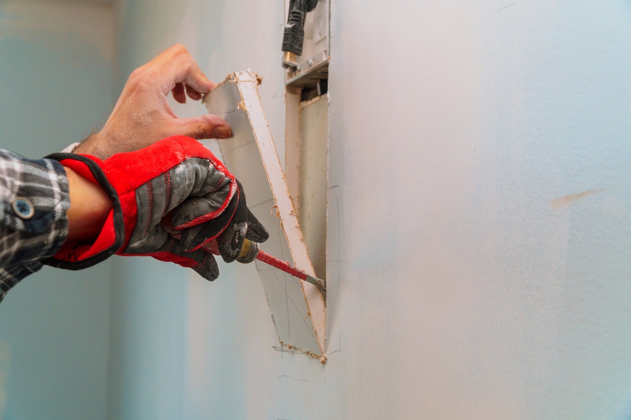 a man repairing drywall