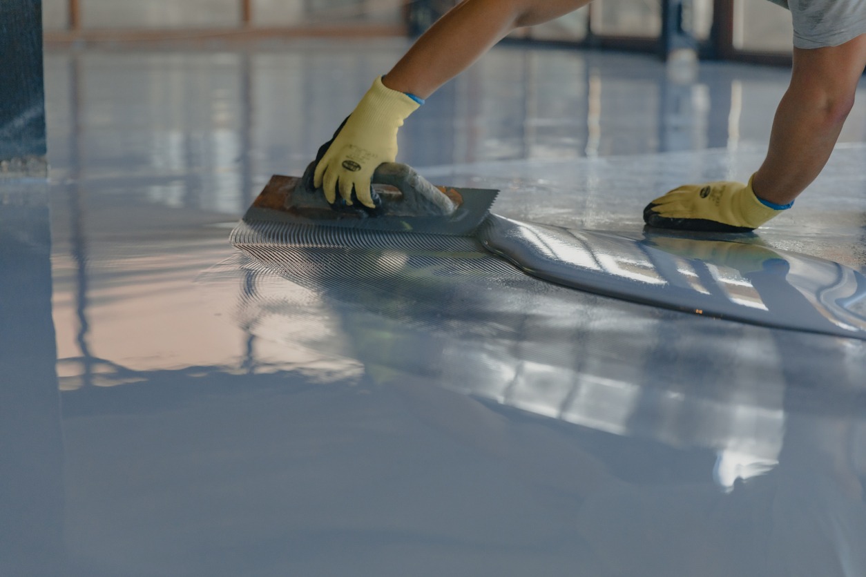 applying gray epoxy resin to the new floor