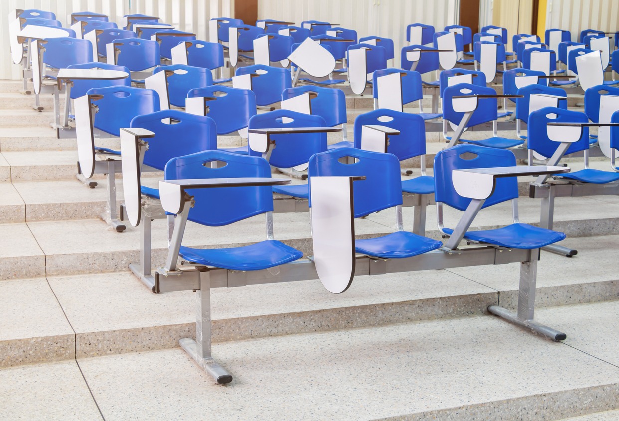 blue lecture chairs in a room with a terrazzo floor
