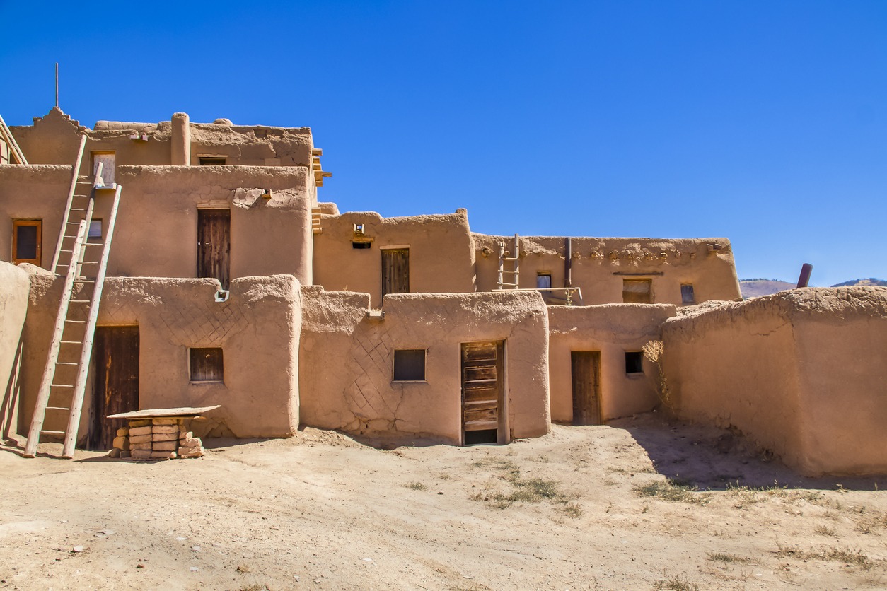 Multi-story adobe buildings from Taos Pueblo in New Mexico where indigenous people are still living after over a thousand years