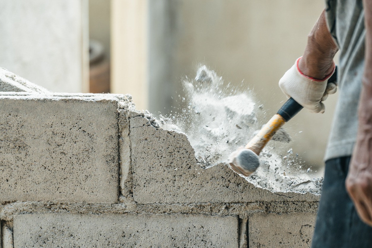 a brick hammer in use for demolition 