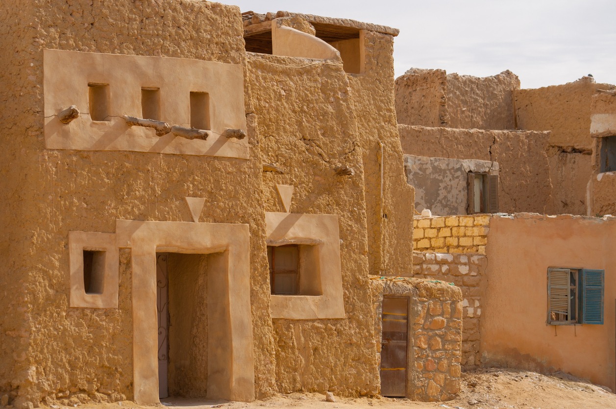 an adobe house exterior with cracks on the wall