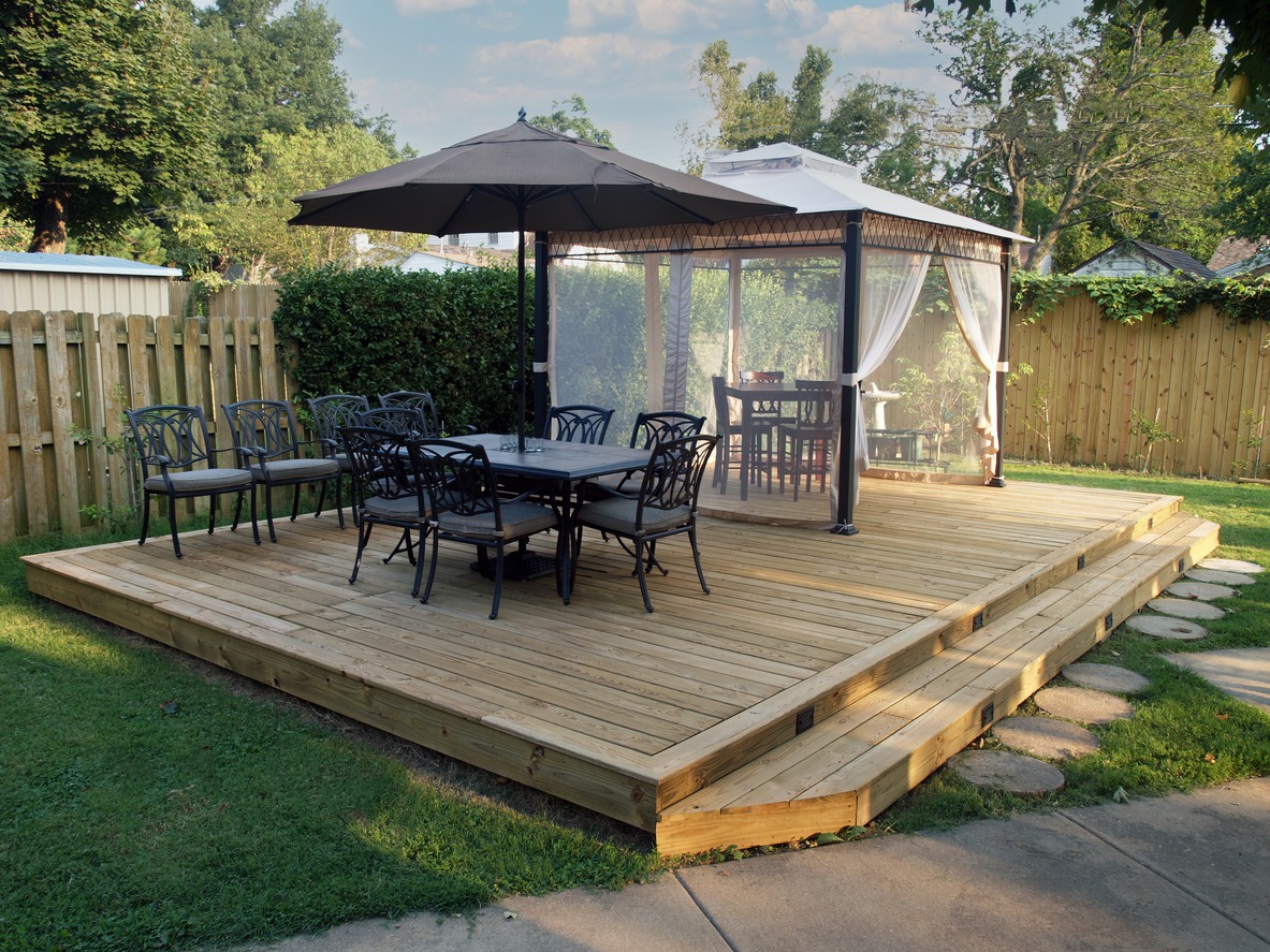 backyard deck with dining and cabana