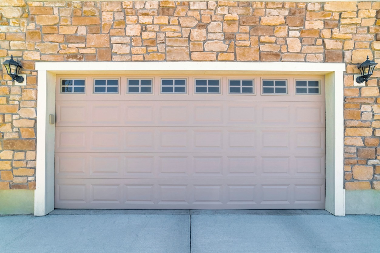 A modern garage door with windows enhancing aesthetic appeal
