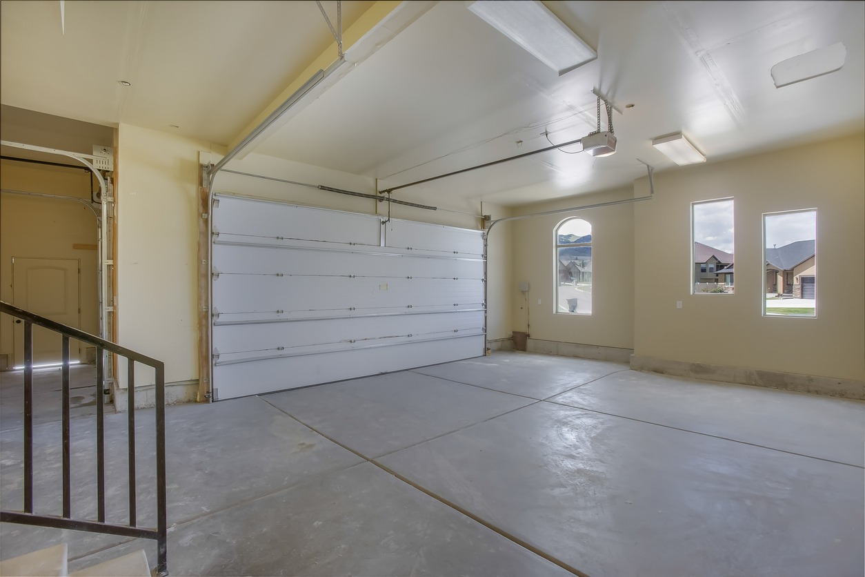 An indoor shot of a newly constructed garage with windows allowing natural light to pass