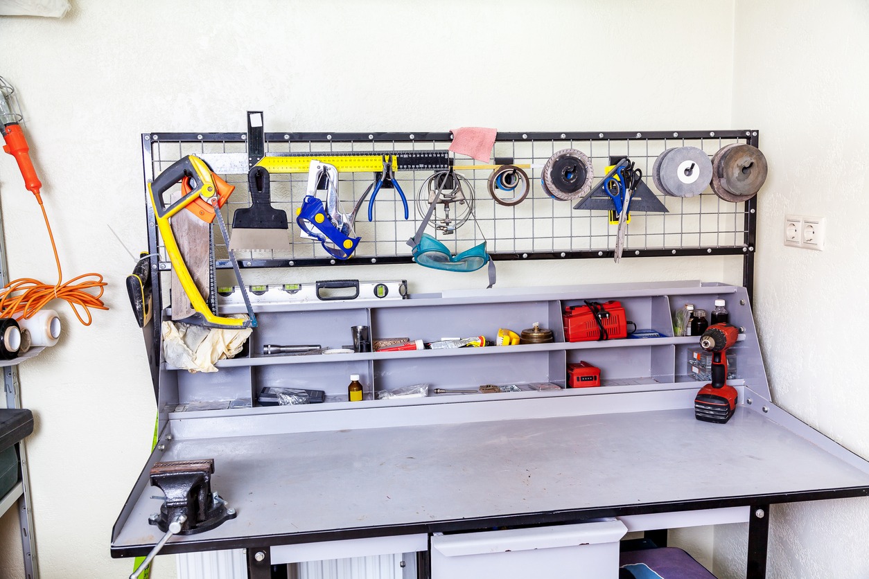 Gray metallic metalwork workbench with a set of different tools in the corner